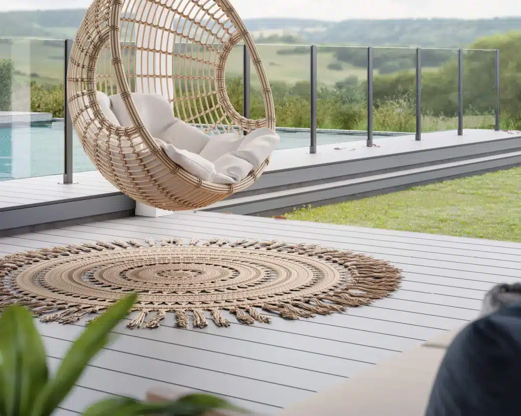 HardieDeck™ fibre cement decking on a modern outdoor deck with glass balustrade beside a pool