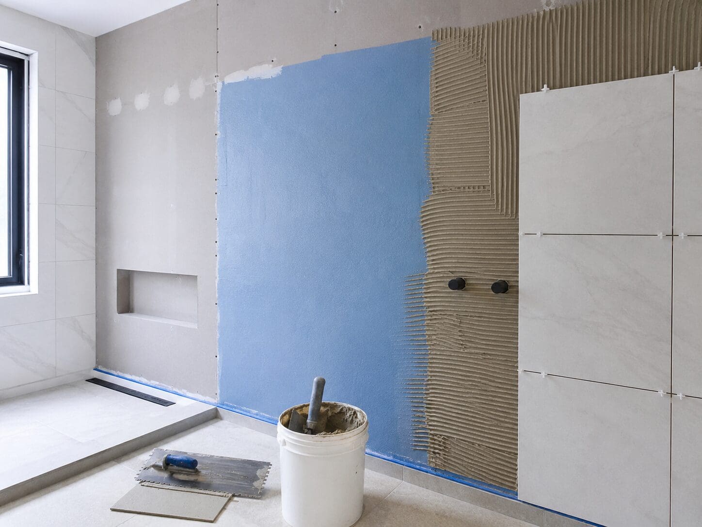 Wet area lining Perth wall system with waterproofing layer tile adhesive and wet-area board preparation.
